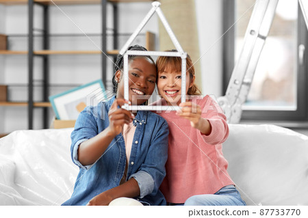 happy smiling women with ruler in shape of house happy smiling women with ruler in shape of house 87733770