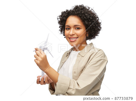 happy woman holding toy wind turbine 87733879