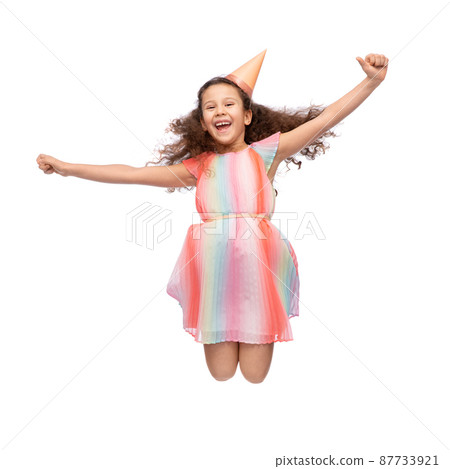 smiling little girl in birthday party hat jumping smiling little girl in birthday party hat jumping 87733921
