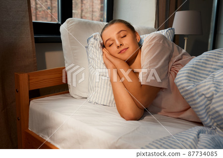 girl sleeping in bed at home 87734085