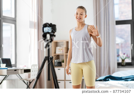 teenage girl or blogger recording gym class video 87734107