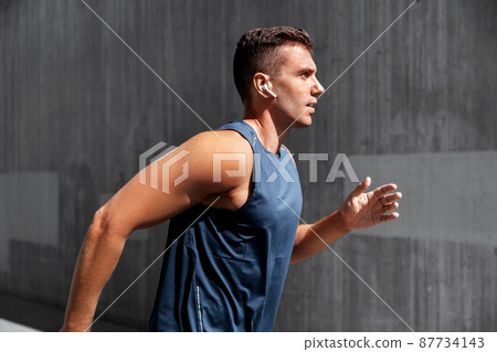 young man in earphones outdoors young man in earphones outdoors 87734143