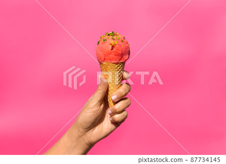 close up of hand holding waffle ice cream cone close up of hand holding waffle ice cream cone 87734145