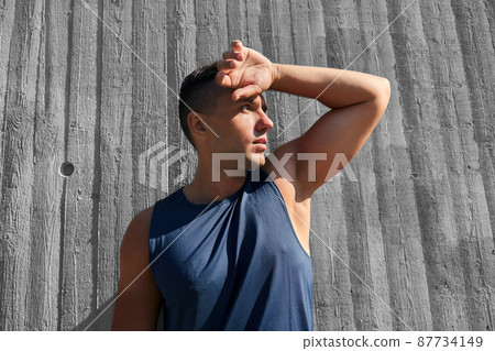 tired young man doing sports outdoors 87734149