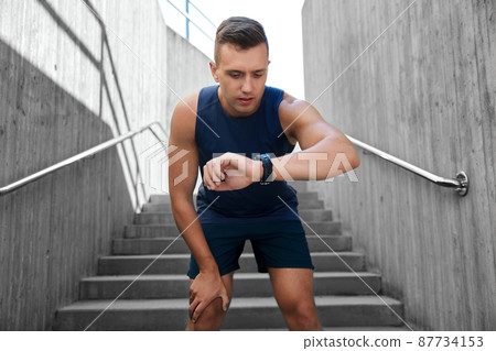 young man with fitness tracker outdoors 87734153