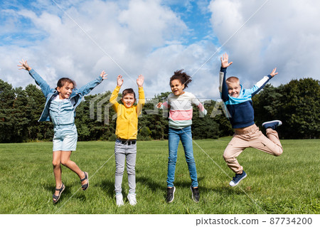 happy children jumping and having fun at park happy children jumping and having fun at park 87734200