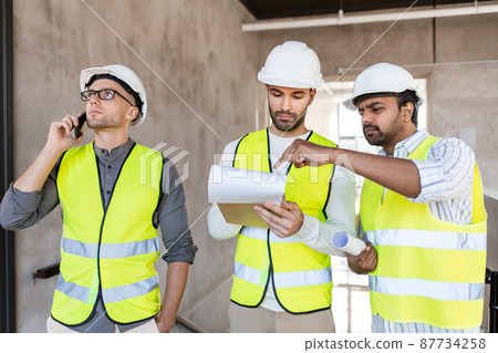 male architects in helmets working at office 87734258
