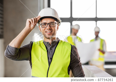 male architect in helmet and safety west at office 87734261