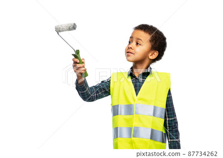 little boy in safety vest with paint roller little boy in safety vest with paint roller 87734262