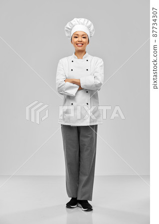 smiling female chef in white jacket 87734307