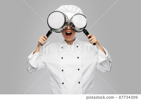 female chef with saucepans having fun female chef with saucepans having fun 87734309