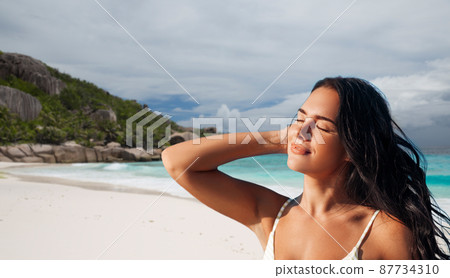 beautiful young woman in bikini swimsuit on beach beautiful young woman in bikini swimsuit on beach 87734310