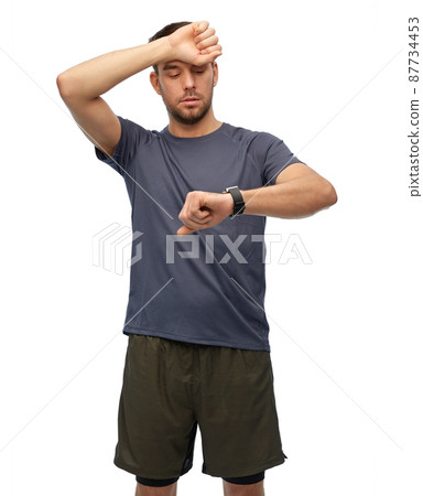 tired man with smart watch or fitness tracker tired man with smart watch or fitness tracker 87734453