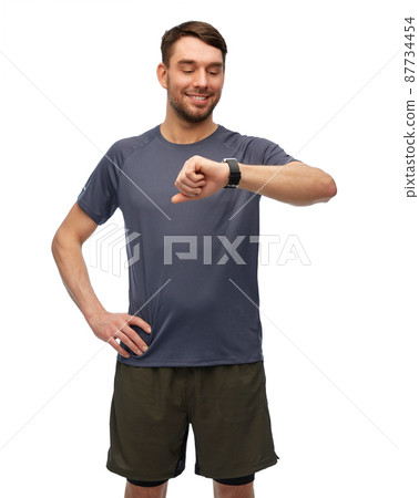 smiling man with smart watch or fitness tracker smiling man with smart watch or fitness tracker 87734454