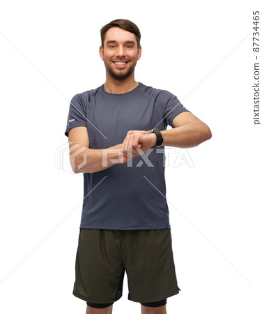 smiling man with smart watch or fitness tracker smiling man with smart watch or fitness tracker 87734465