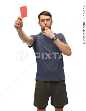 referee whistling whistle and showing red card 87734479