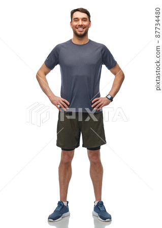 smiling man with smart watch or fitness tracker 87734480