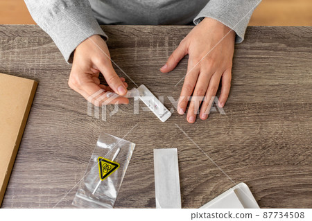 woman making self testing coronavirus test at home 87734508
