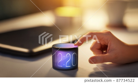 close up of hand with time on smart speaker close up of hand with time on smart speaker 87734522
