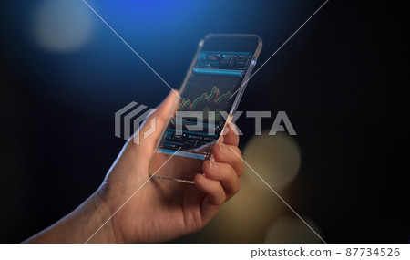 hand with forex chart on transparent smartphone 87734526