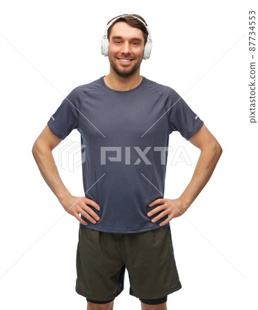 smiling man in sports clothes with headphones smiling man in sports clothes with headphones 87734553