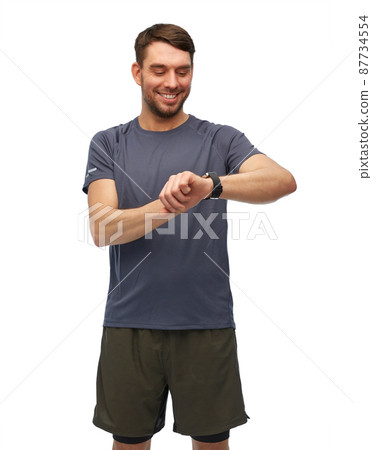 smiling man with smart watch or fitness tracker smiling man with smart watch or fitness tracker 87734554