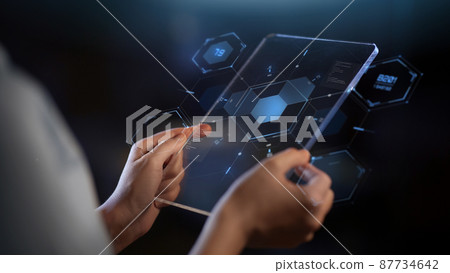 hands with transparent tablet pc and hologram 87734642
