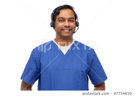 smiling indian doctor or male nurse with headset smiling indian doctor or male nurse with headset 87734650