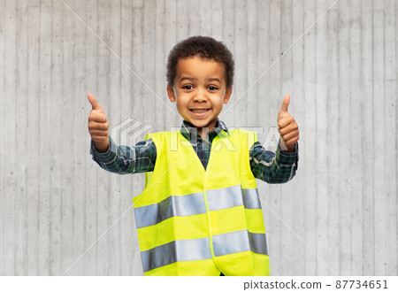 happy little boy in safety vest showing thumbs up happy little boy in safety vest showing thumbs up 87734651