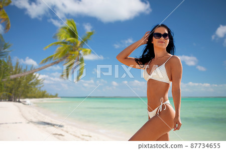smiling young woman in bikini swimsuit on beach smiling young woman in bikini swimsuit on beach 87734655
