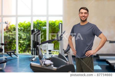 smiling man in sports clothes in gym 87734660