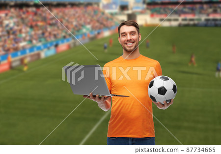 man or football fan with soccer ball and laptop man or football fan with soccer ball and laptop 87734665
