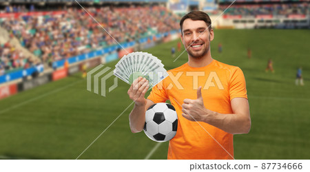 happy football fan with soccer ball and money happy football fan with soccer ball and money 87734666