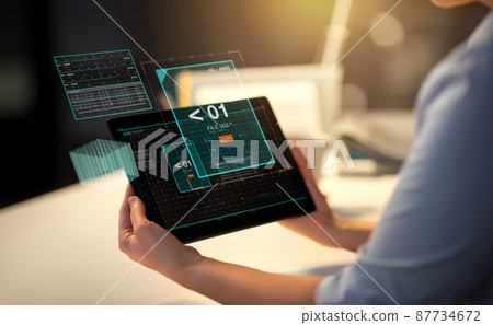 businesswoman with tablet computer at night office businesswoman with tablet computer at night office 87734672