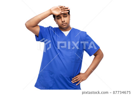 stressed doctor or male nurse in blue uniform 87734675