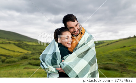 happy couple in warm blanket in ireland 87734682