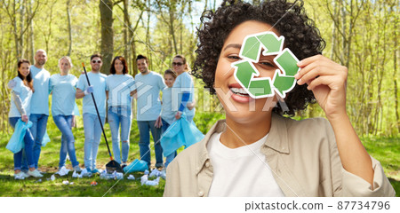 happy woman looking through green recycling sign happy woman looking through green recycling sign 87734796