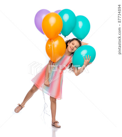 happy girl in birthday party hat with balloons 87734894