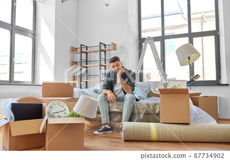 sad man with boxes moving to new home sad man with boxes moving to new home 87734902