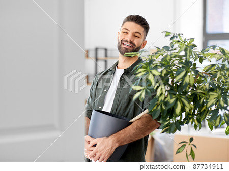 happy man with flower moving to new home 87734911