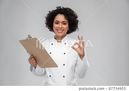 smiling female chef with clipboard smiling female chef with clipboard 87734955