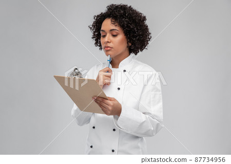 thinking female chef with clipboard and pen thinking female chef with clipboard and pen 87734956