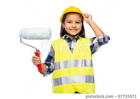 girl in helmet and safety vest with paint roller girl in helmet and safety vest with paint roller 87735071
