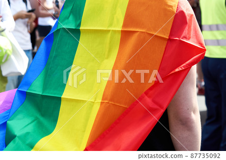 Close up of rainbow flag cape worn over shoulders by CSD participant Close up of rainbow flag cape worn over shoulders by CSD participant 87735092