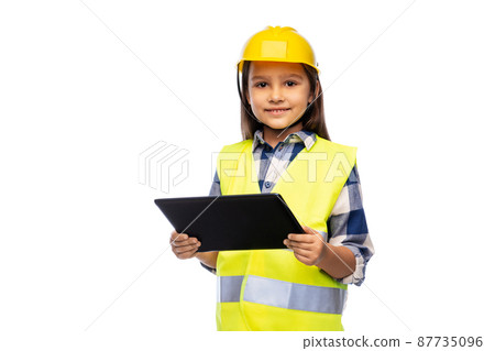 girl in helmet and safety vest with tablet pc girl in helmet and safety vest with tablet pc 87735096