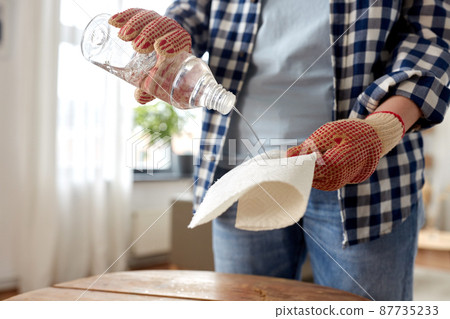 woman degreasing old table surface with solvent woman degreasing old table surface with solvent 87735233