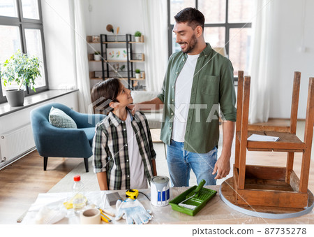 father and son restoring old table at home 87735278