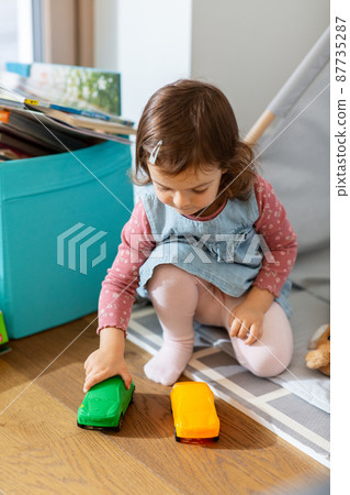 baby girl playing with toy cars in teepee at home baby girl playing with toy cars in teepee at home 87735287
