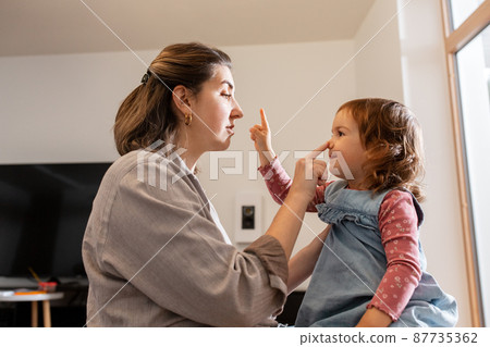 happy mother and daughter playing at home happy mother and daughter playing at home 87735362