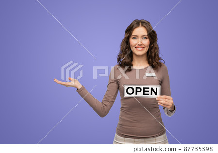 happy female shop assistant with open sign happy female shop assistant with open sign 87735398